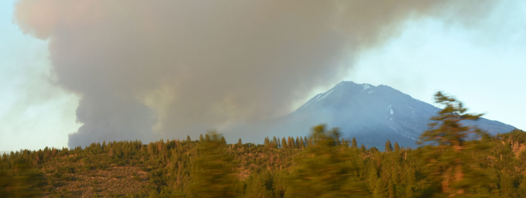 A plume of smoke over a mountain.