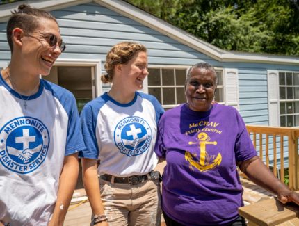 Photo of two young volunteers with a homeowner in South Carolina.