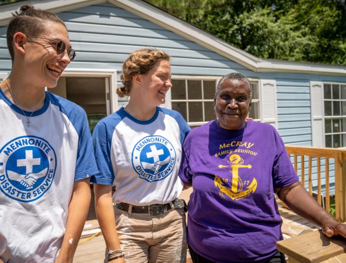 Photo of two young volunteers with a homeowner in South Carolina.