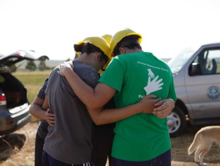 MDS volunteers encircled praying.