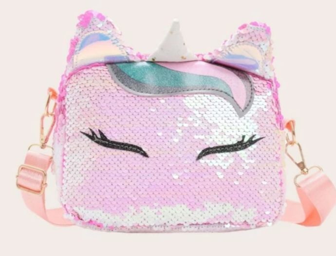 A photo of a pink sequined purse in the shape of a unicorn's head.