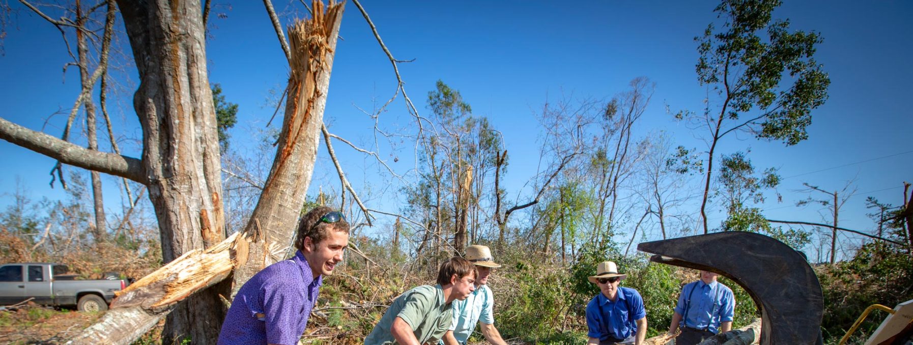 Photo of volunteers clearing debris and trees in Marianna, Florida.