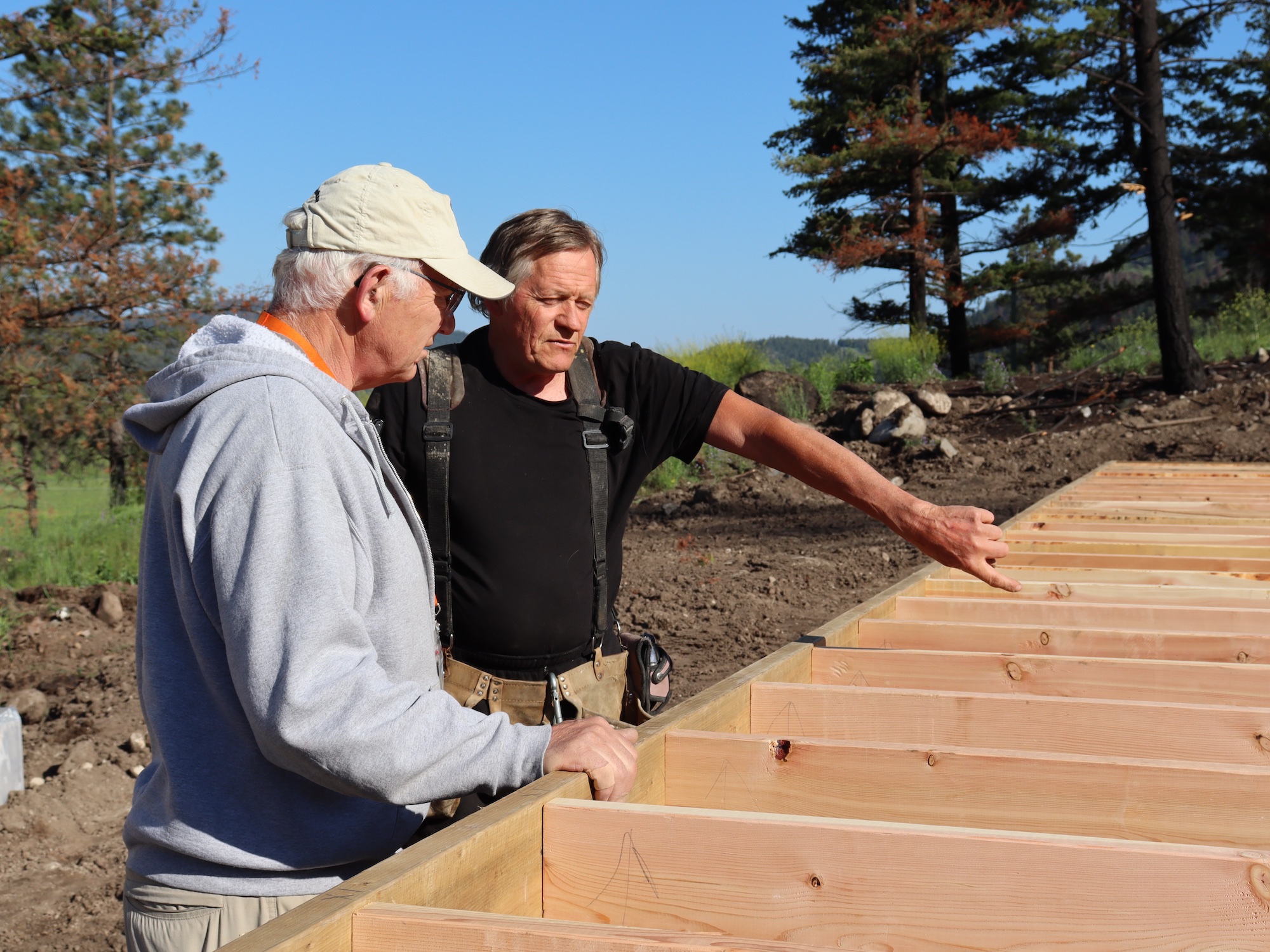 Monte Lake, volunteers work with lumber outdoors.