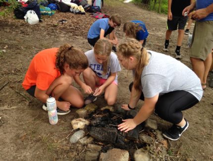 Campers working on a fire at the Amigo Centre in southern Michigan.