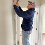 Volunteer indoors working on the finishing touches of a home.