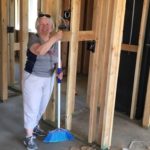 An MDS volunteer standing inside of a newly framed home in Paradise, CA
