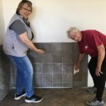 Two MDS volunteers working on a tile wall in paradise, CA