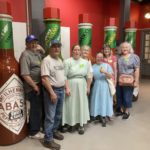 Group from Jennings taking a photo in front of Tabasco products (perhaps a museum)