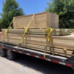 Load of lumber tied down to a flatbed ready for use