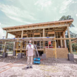 Shirley Zeno standing in front of her new home that is being constructed by MDS volunteers