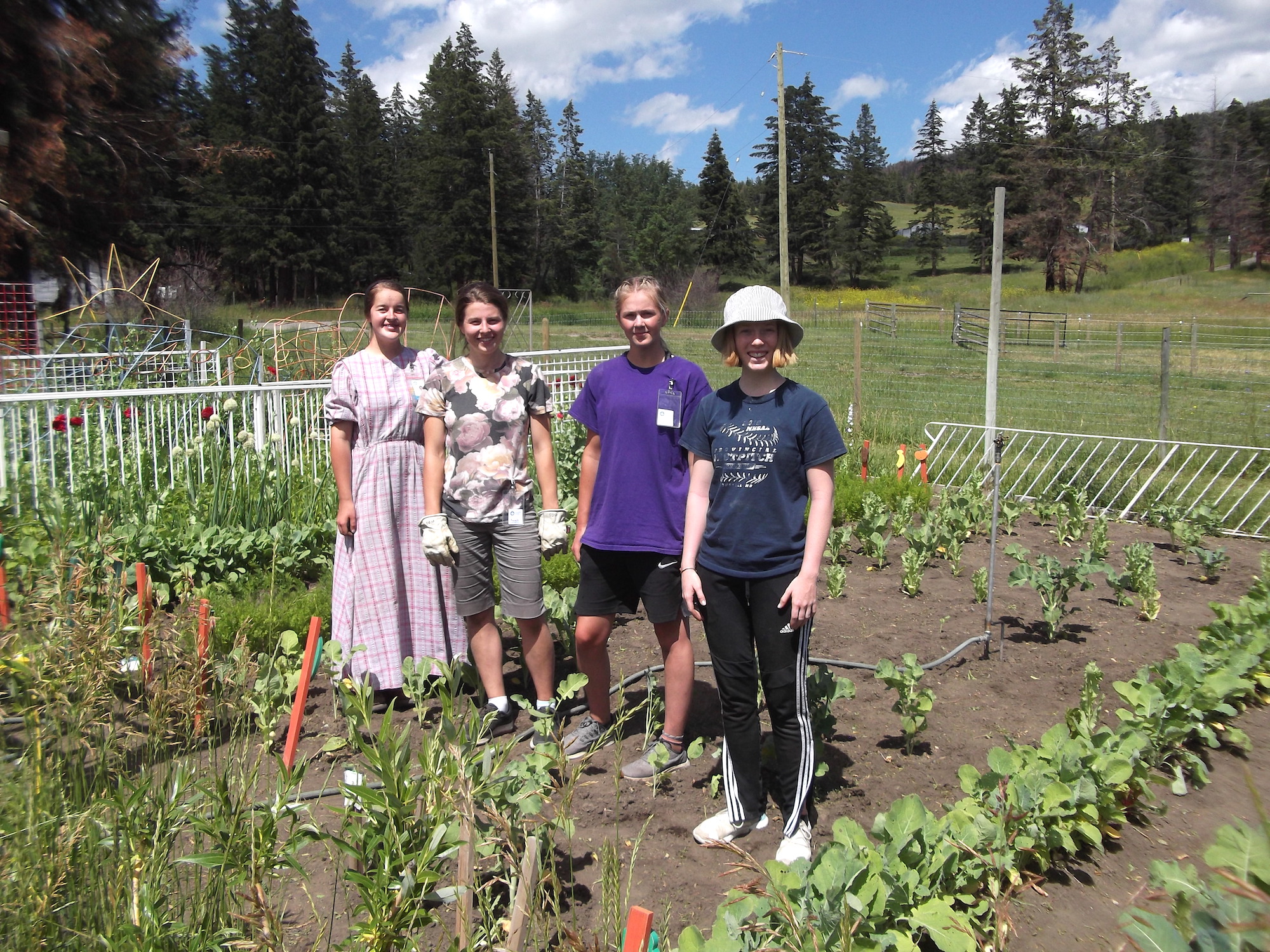 Volunteers in Monte Lake pose for a small group image in a garden