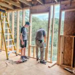 Volunteers from Newton, KS work on framing a new build in Welsh LA