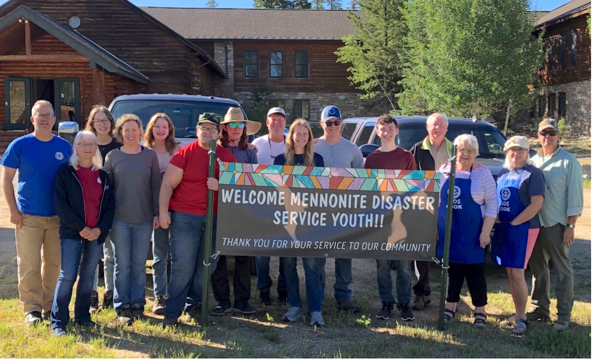 Group photo of youth and adults in Grand Lake, CO. Picture taken in front of Base Camp