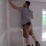 Zach Bomberger (weekly volunteer) working on drywall