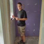 Jonas Schmidt (yearlong volunteer) working on drywall