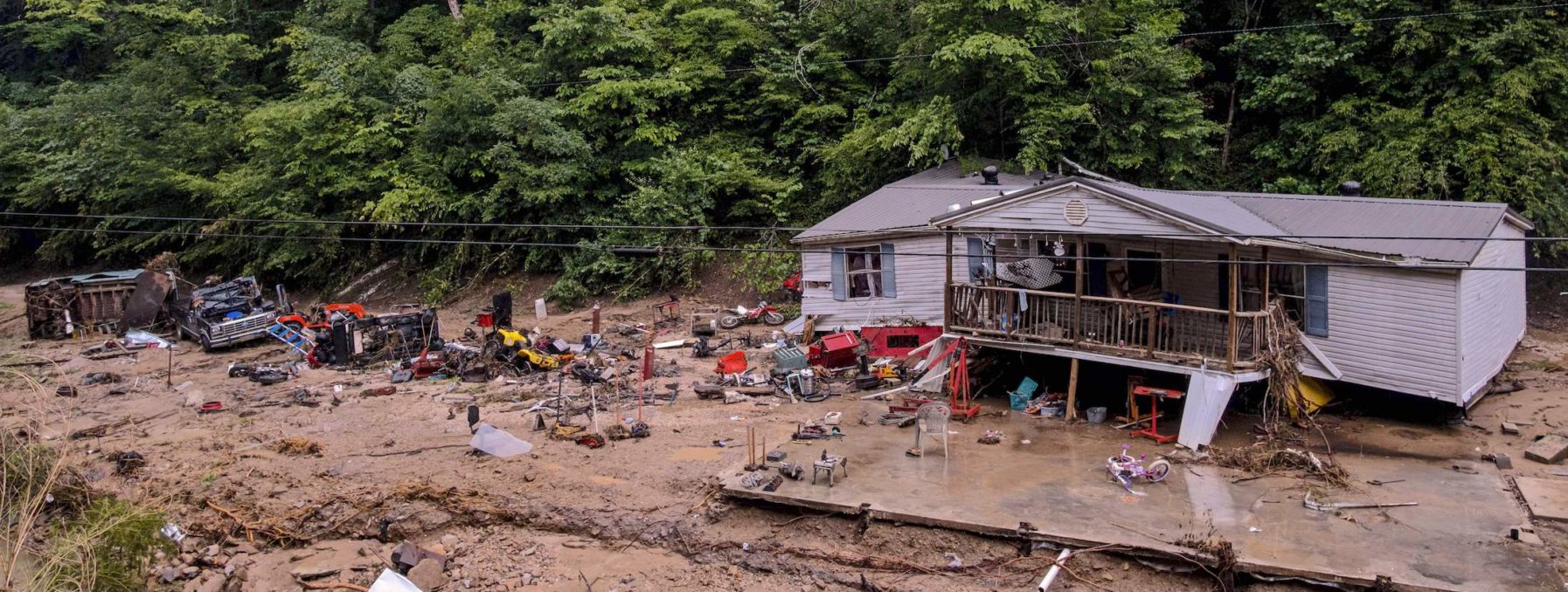 Distruction caused by flooding in Kentucky, image shows a home carried away from its foundation.