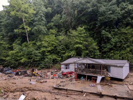Distruction caused by flooding in Kentucky, image shows a home carried away from its foundation.