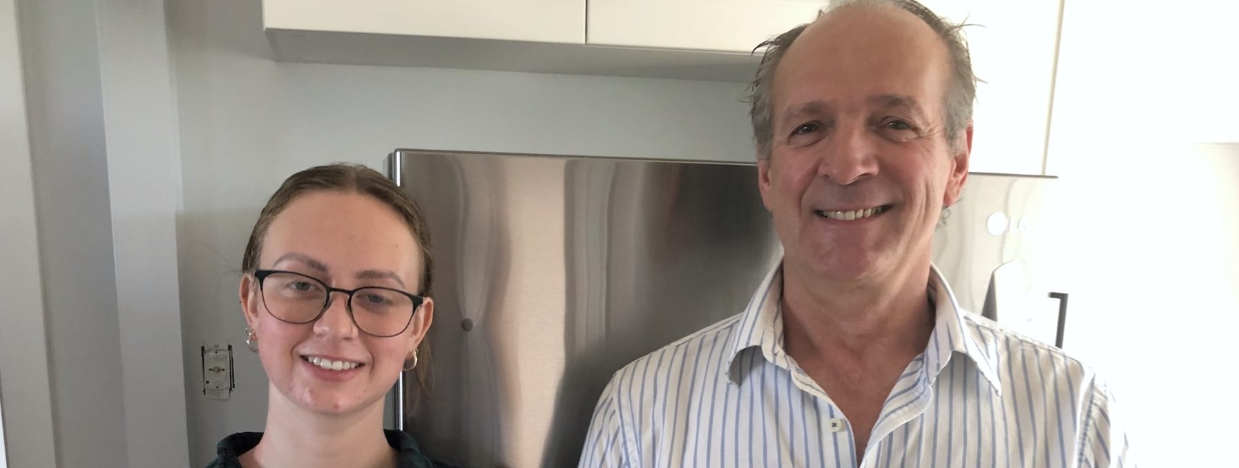 Michelle and Ted Swanson pose for a picture inside a kitchen
