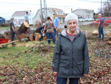 Old Colony Edith Ball in her backyard as Old Colony church members clean up fallen trees.