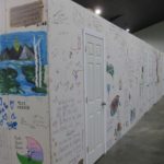 Wall for lodging room in Jennings covered in art and writing by volunteers