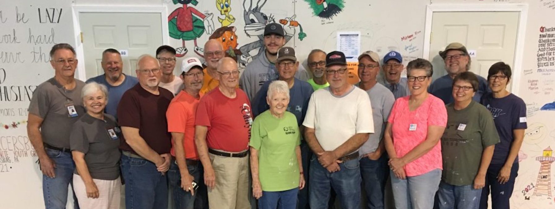 Sara Frey Poses in a green shirt among other volunteers in Jennings, LA