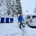 Volunteer from Canada kicks snow in Paradise California