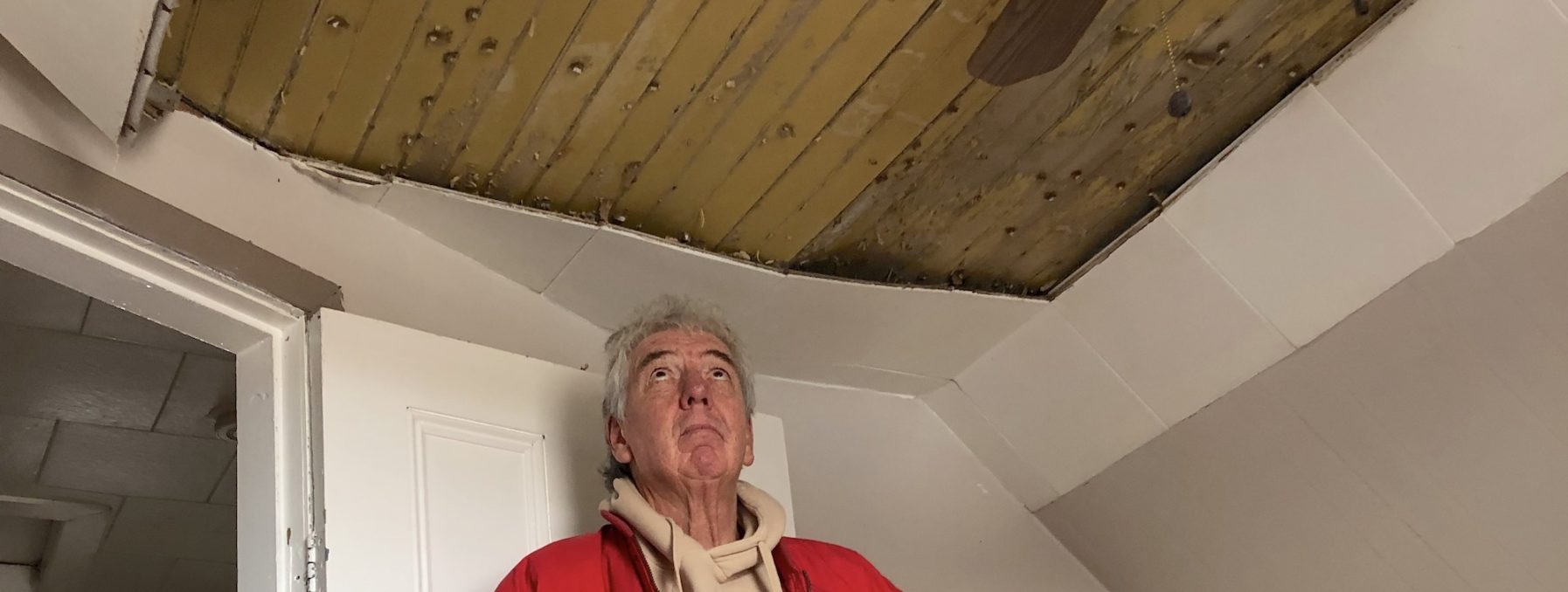 James Towers stares up at a damaged ceiling in Nova Scotia