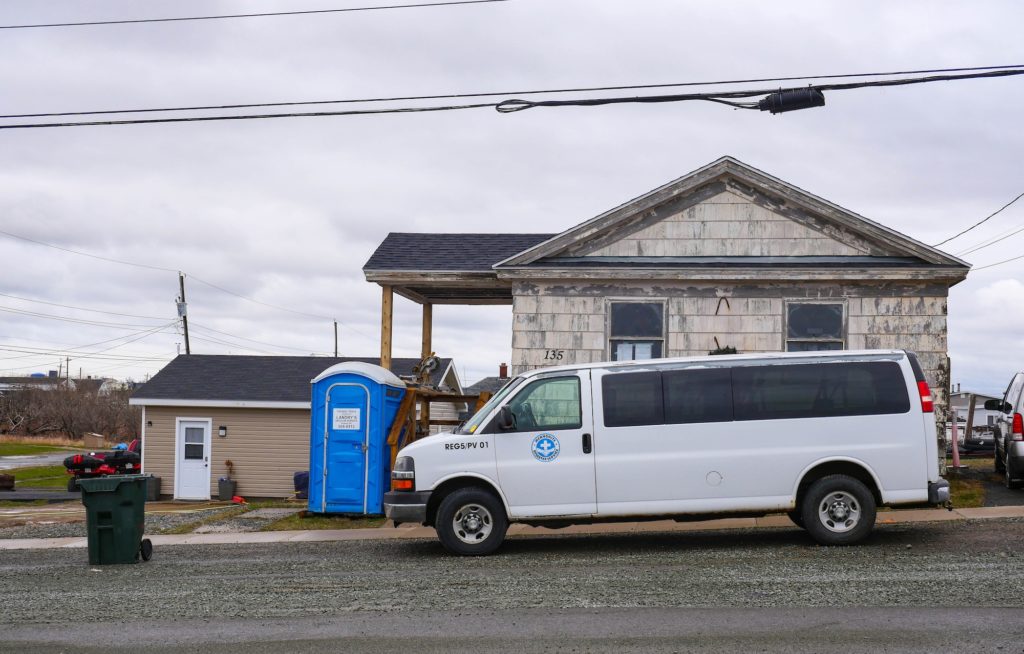 An MDS van in front of house being repaired in Glace Bay.