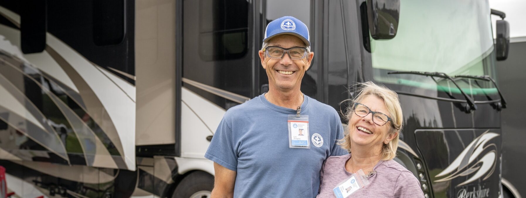 A couple stands in front of their RV at an MDS response