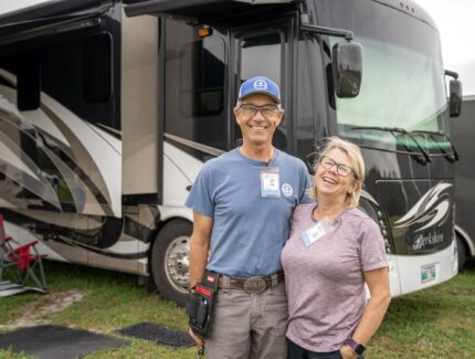 A couple stands in front of their RV at an MDS response