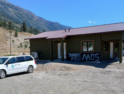 A volunteer built house with "Thank you MDS!" sign in front.