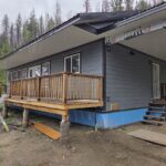 A house in construction with a deck and siding installed