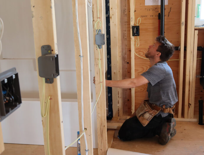 A man installs a bathtub