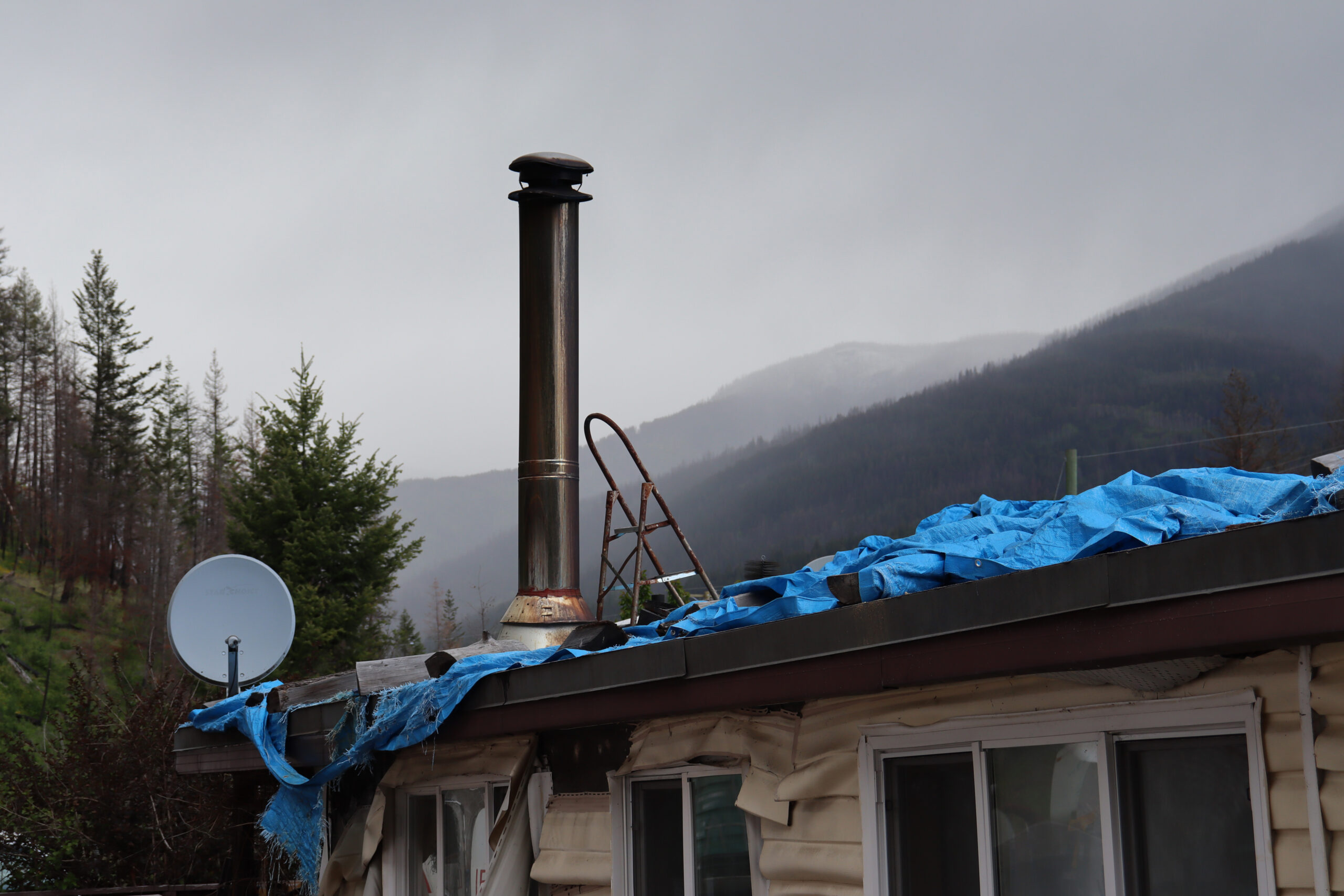 A trailer home damaged by flooding and fire