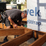 A volunteer installs a deck