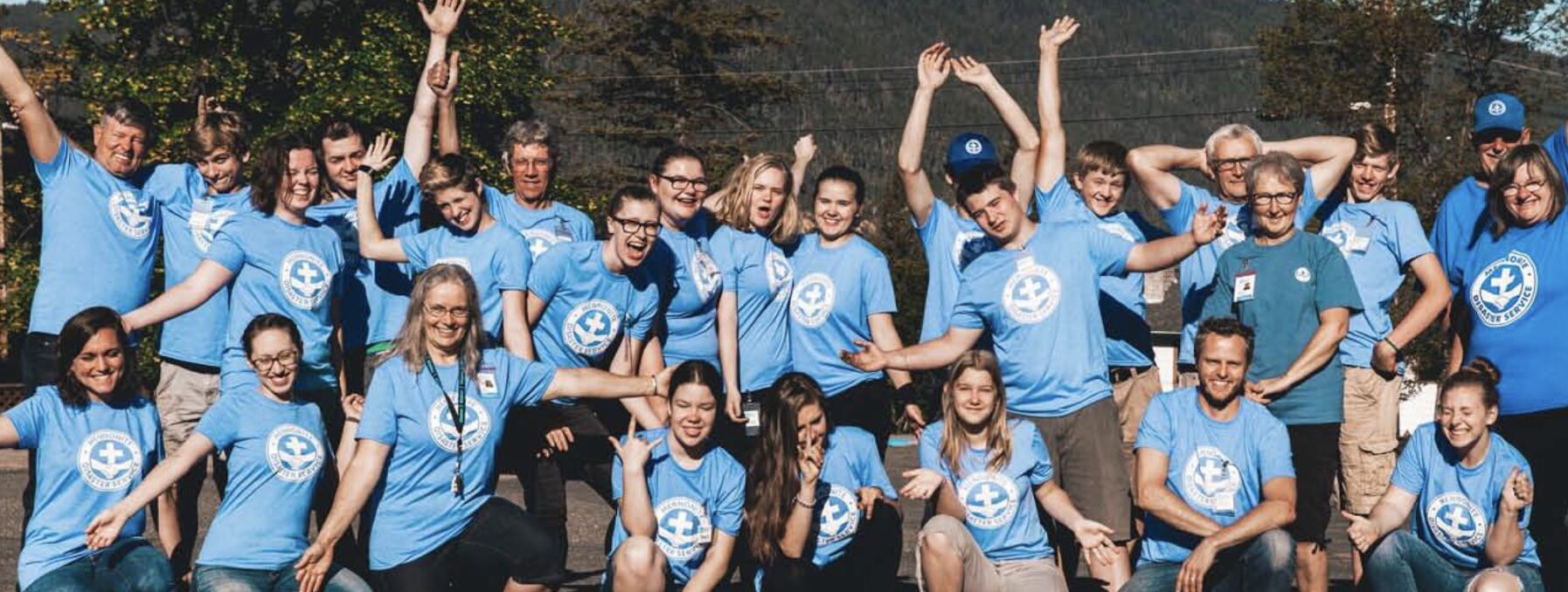Kinection Hero Image for MDS Story. Image of a volunteer group in matching blue shirts.