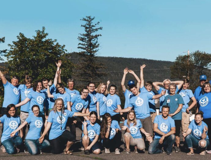 Kinection Hero Image for MDS Story. Image of a volunteer group in matching blue shirts.
