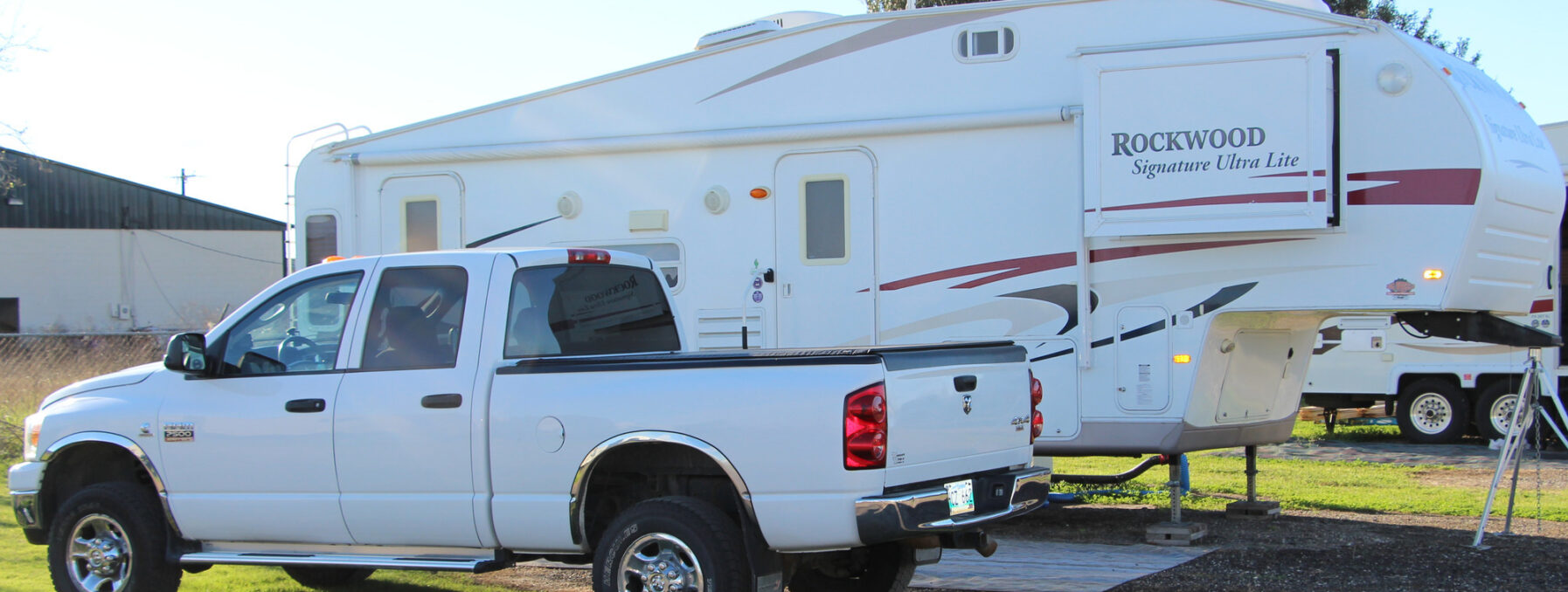 A white pickup truck and camper