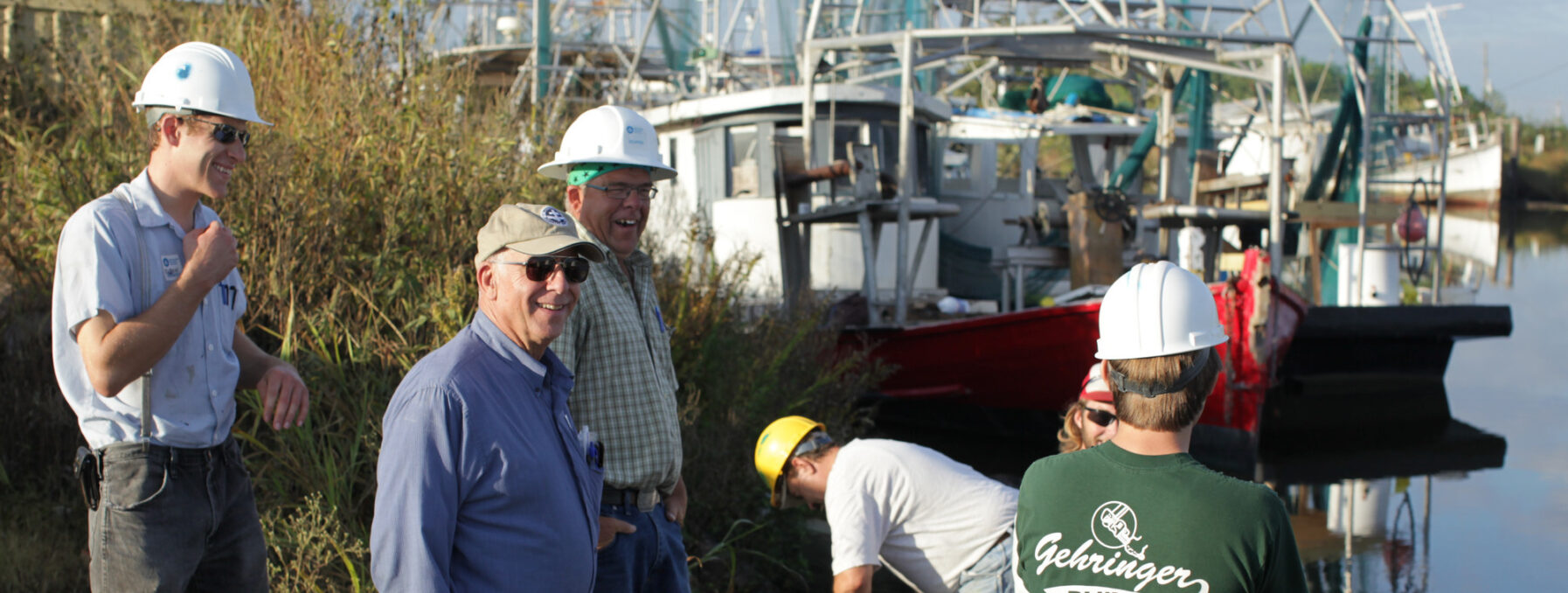 MDS responders talking on the coast by fishing boats