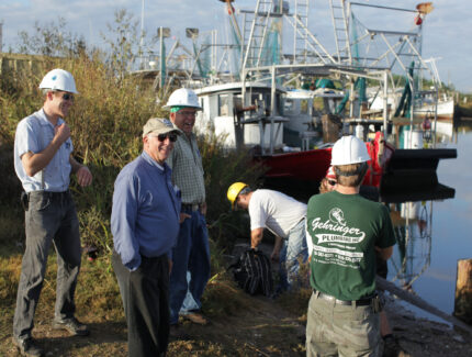 MDS responders talking on the coast by fishing boats