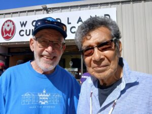 Two men posing together for a picture.