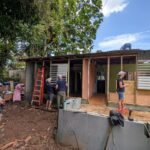 People working on a house under construction.