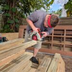 Man cuts wood with a skill saw.