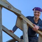 Man working on roof poses for a picutre.