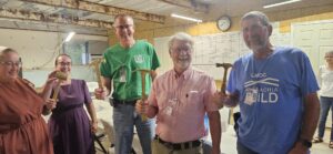 MDS volunteers holding Golden Hammer awards in West Asheville, NC
