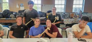 MDS volunteers holding Golden Hammer awards in West Asheville, NC